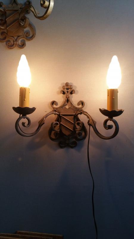 Pairs of wrought iron wall lights with coat of arms;