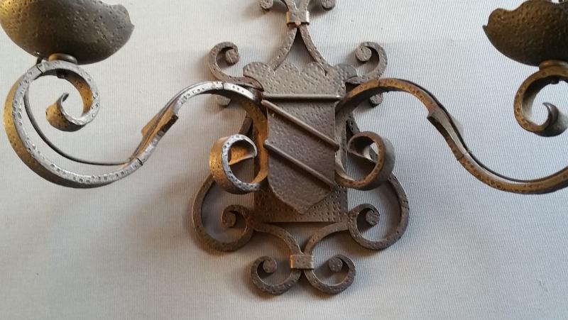 Pairs of wrought iron wall lights with coat of arms;