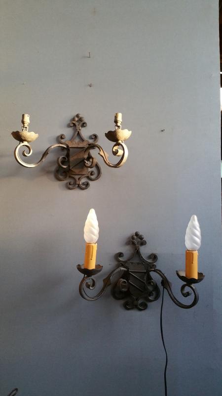 Pairs of wrought iron wall lights with coat of arms;