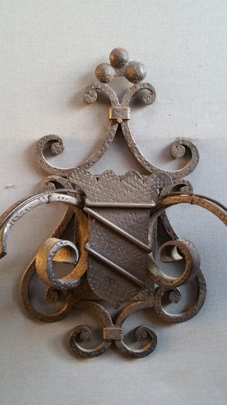 Pairs of wrought iron wall lights with coat of arms;